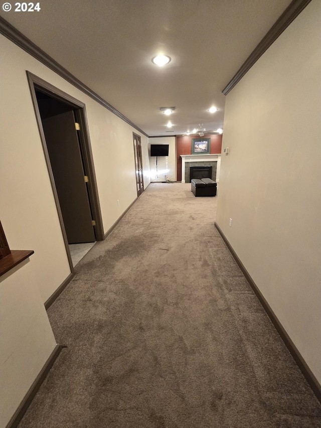 hallway featuring crown molding and light carpet