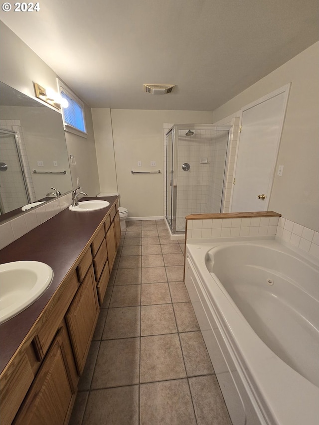 full bathroom featuring tile patterned flooring, toilet, independent shower and bath, and vanity