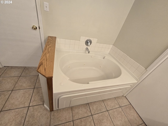 bathroom with tile patterned flooring and a tub