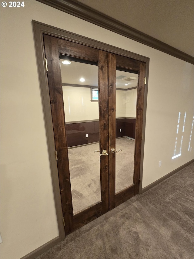 details featuring carpet, crown molding, and french doors