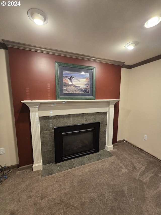 room details featuring carpet, a tiled fireplace, and ornamental molding