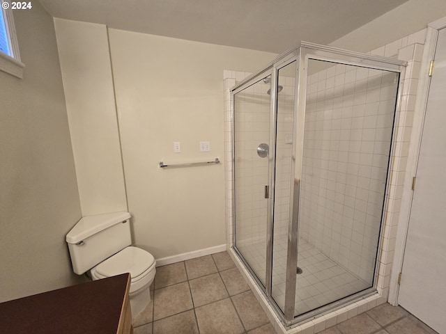 bathroom featuring tile patterned floors, an enclosed shower, and toilet