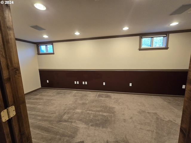 basement featuring carpet floors and ornamental molding