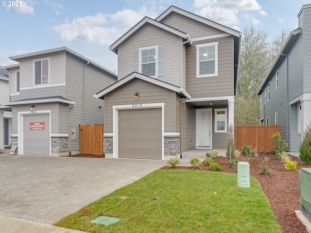 craftsman house with a garage and a front yard