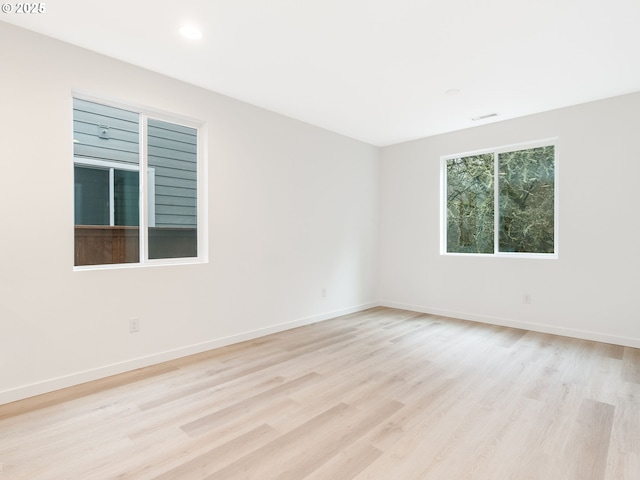 spare room with light hardwood / wood-style flooring