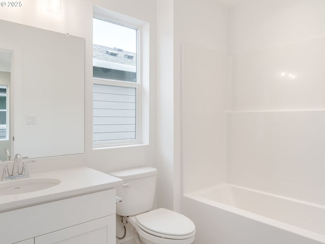 full bathroom featuring vanity, bathtub / shower combination, and toilet