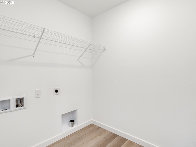 clothes washing area featuring wood-type flooring, washer hookup, and hookup for an electric dryer