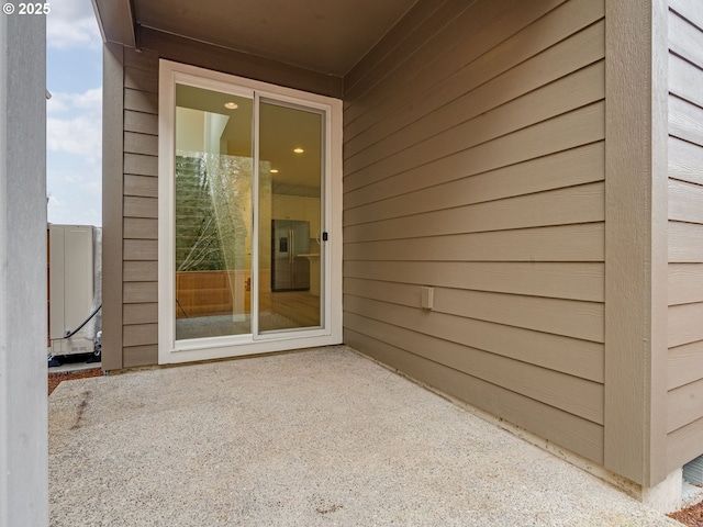 property entrance featuring a patio