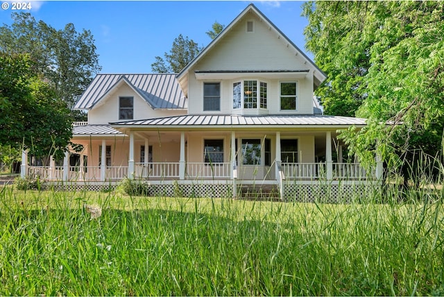 view of front of home with a porch and a front lawn