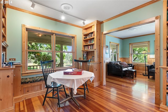 dining space featuring ornamental molding and hardwood / wood-style floors