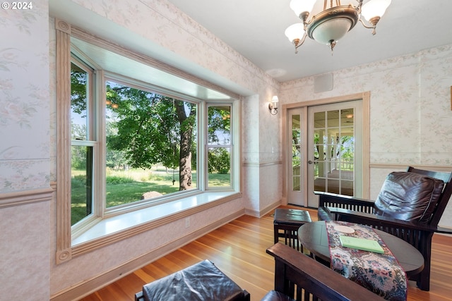 sunroom featuring an inviting chandelier