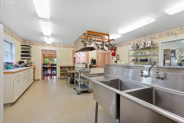 kitchen with white cabinetry and sink