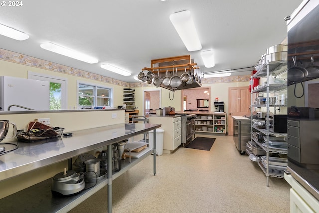 interior space featuring white refrigerator and stainless steel counters