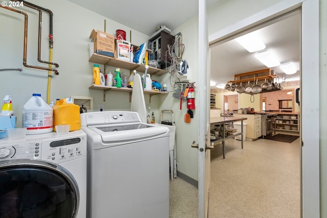 washroom with a workshop area and independent washer and dryer