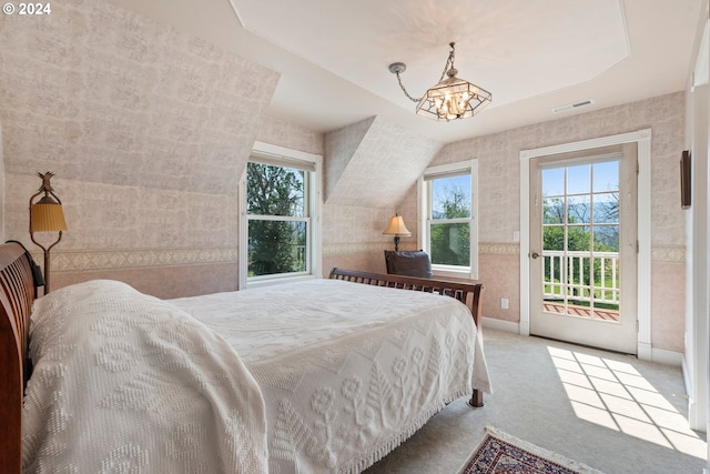 bedroom with an inviting chandelier, light colored carpet, and access to exterior