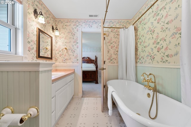 bathroom with vanity, radiator, and a bath