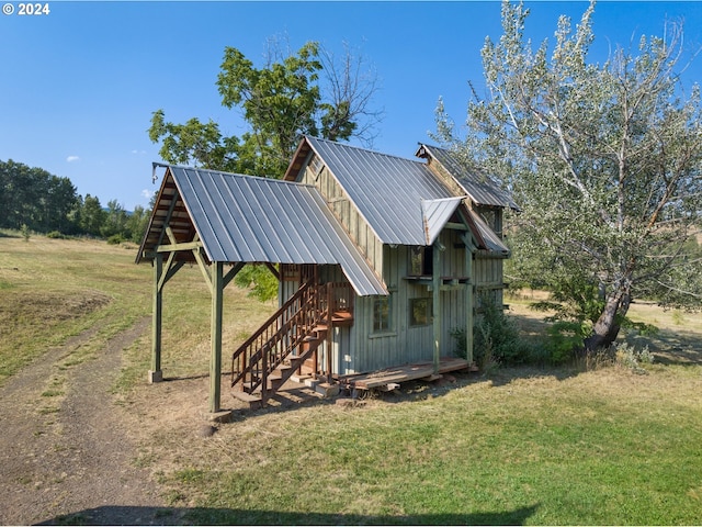 exterior space featuring an outbuilding and a lawn