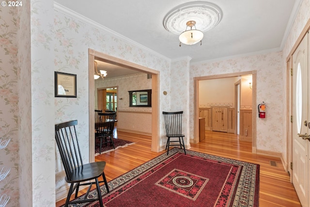 interior space with crown molding, wood-type flooring, and plenty of natural light