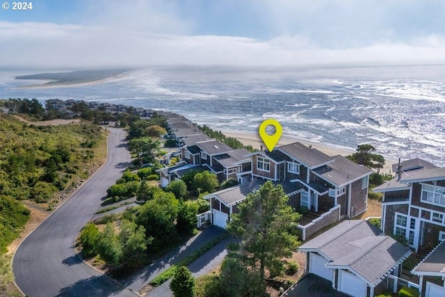 bird's eye view featuring a water view and a beach view