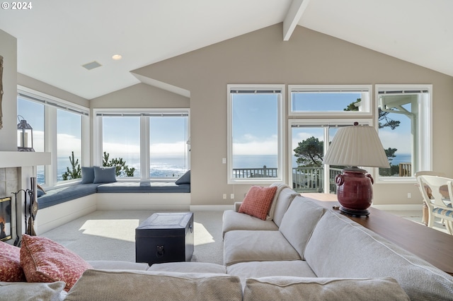 carpeted living room with lofted ceiling with beams and a fireplace