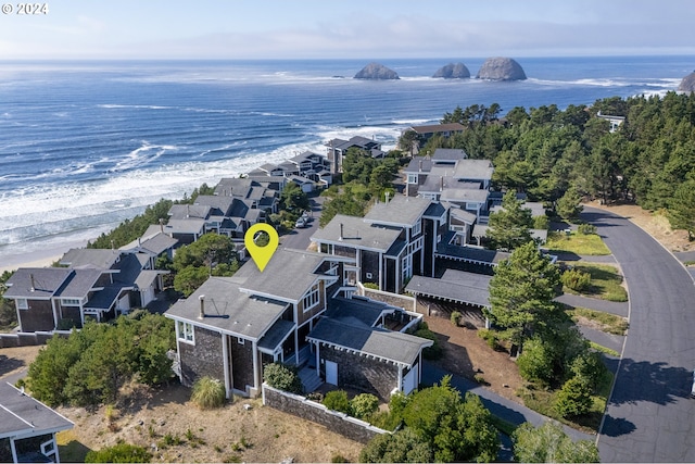 drone / aerial view with a water view and a beach view