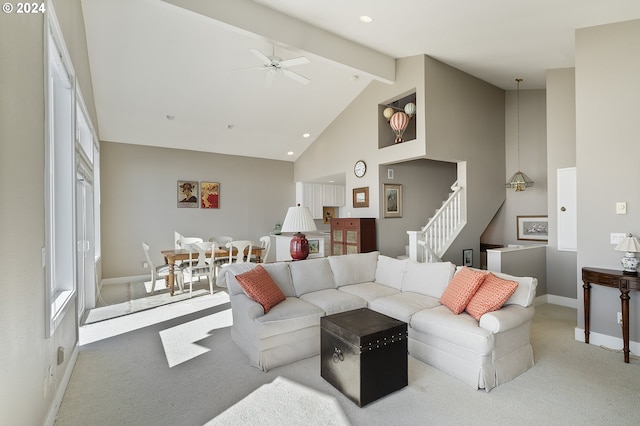 carpeted living room featuring beam ceiling, high vaulted ceiling, and ceiling fan