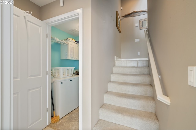 stairway featuring washer / dryer