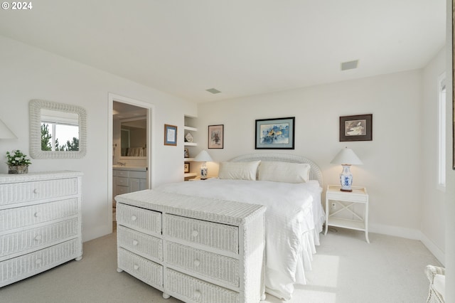 carpeted bedroom featuring ensuite bathroom