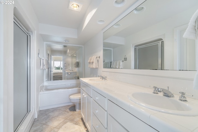 bathroom featuring a tub, toilet, tile patterned flooring, and vanity