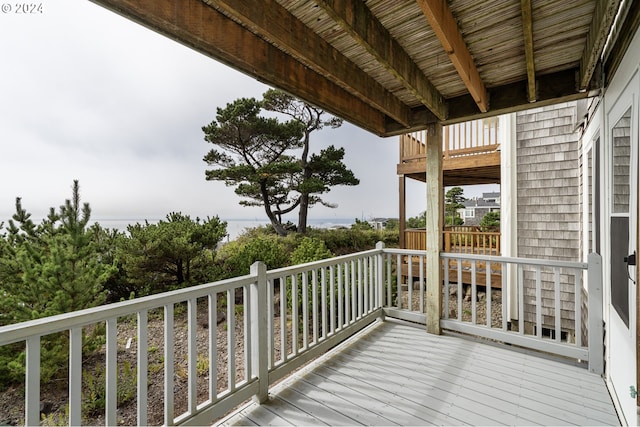 wooden terrace featuring a water view