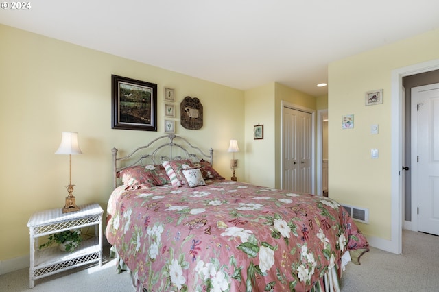 bedroom with a closet and light colored carpet