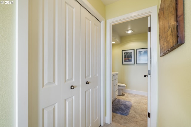 hall with light tile patterned floors