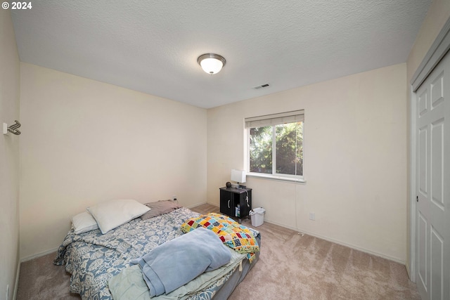 10909 SW Adele Dr, Portland, OR 97225 - carpeted bedroom with baseboards, a textured ceiling, and a closet
