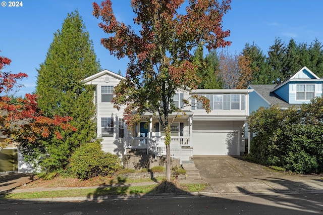10909 SW Adele Dr, Portland, OR 97225 - obstructed view of property featuring concrete driveway, a garage, and a porch