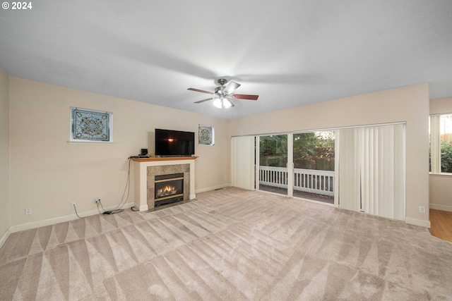 10909 SW Adele Dr, Portland, OR 97225 - unfurnished living room with a fireplace, carpet floors, ceiling fan, and baseboards