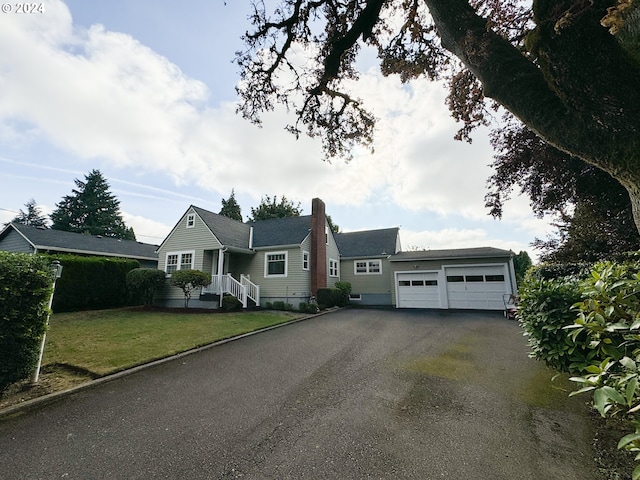 single story home featuring a front yard and a garage