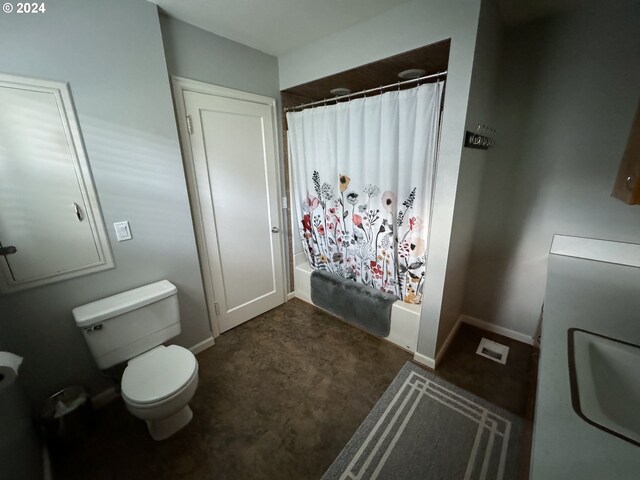 bathroom featuring curtained shower and toilet