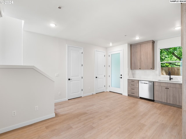 kitchen featuring backsplash, dishwasher, light hardwood / wood-style floors, and sink