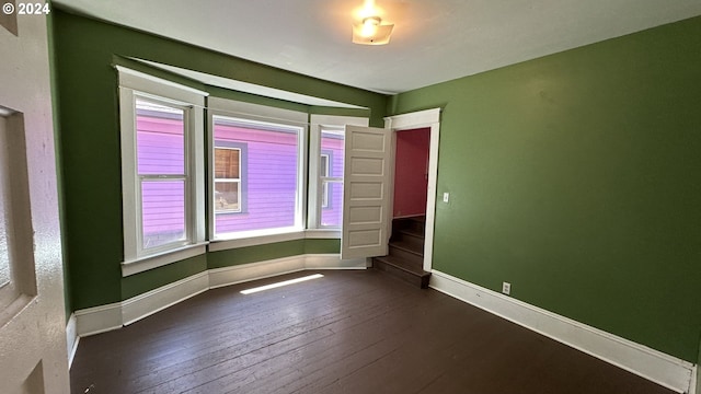 spare room featuring dark hardwood / wood-style floors