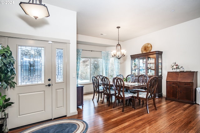 dining area featuring a chandelier and dark hardwood / wood-style floors