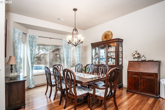 dining area with a notable chandelier and light wood-type flooring