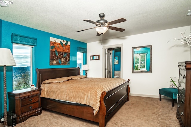 carpeted bedroom with multiple windows, ceiling fan, and a textured ceiling