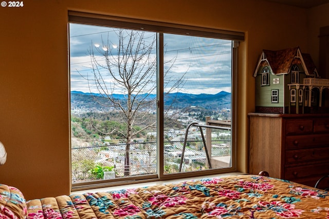 bedroom featuring a mountain view