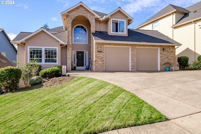 front of property with a front lawn and a garage