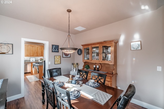 dining area featuring wood finished floors and baseboards