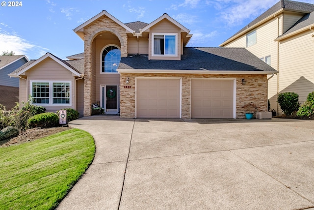 front facade featuring a front yard and a garage