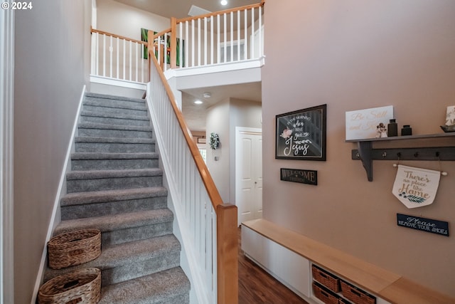 staircase with hardwood / wood-style floors