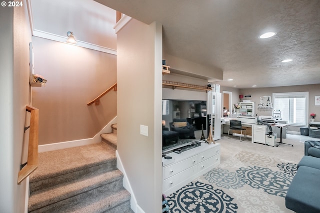 living area featuring light colored carpet, recessed lighting, stairs, a desk, and baseboards