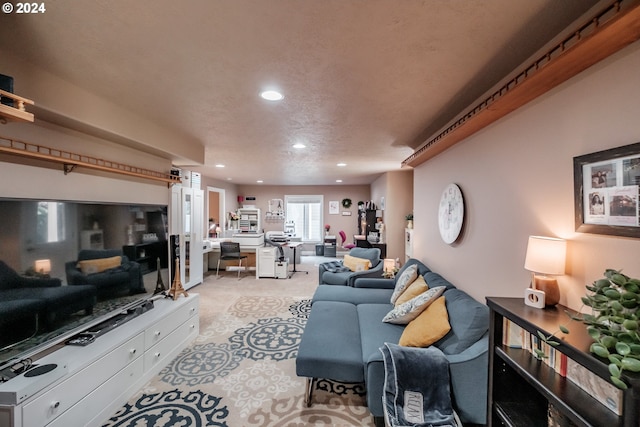 living room featuring a textured ceiling and light colored carpet