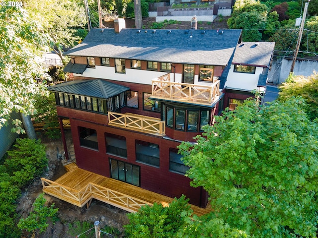 rear view of house featuring a balcony